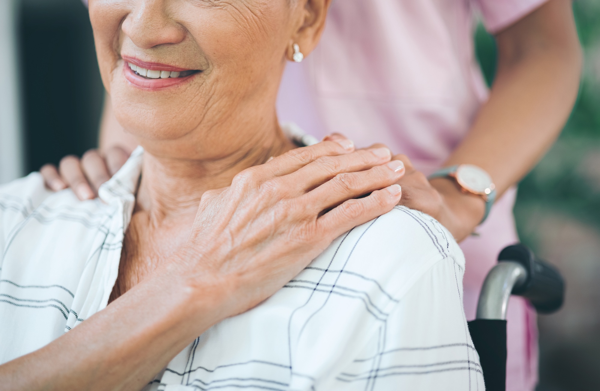 Cropped shot of a nurse caring for an older woman in a wheelchair